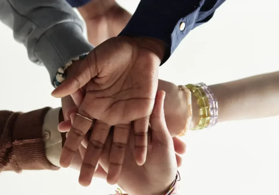 Hands joined together in a show of unity and support.